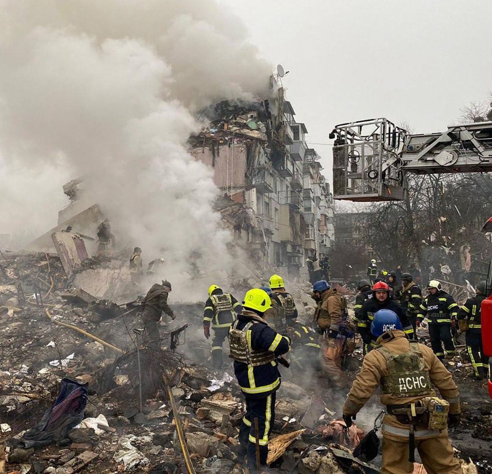 Firefighters at the scene of a damaged building after a Russian missile strike in Poltava, Ukraine.