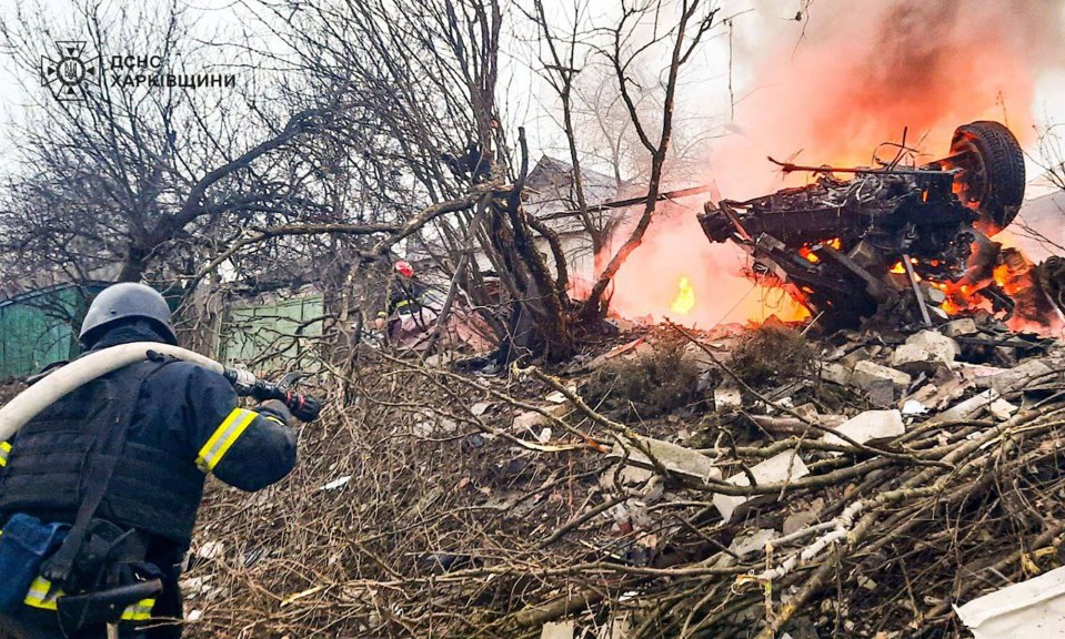 Firefighter battling blaze amid rubble in Kharkiv, Ukraine.