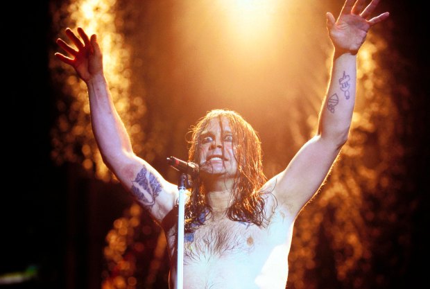 Ozzy Osbourne performing onstage with Black Sabbath.