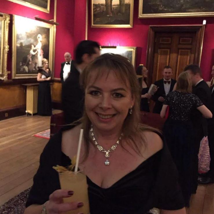 Woman at a formal event holding a cocktail.