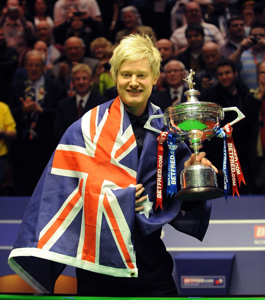 Neil Robertson holding a trophy and an Australian flag.