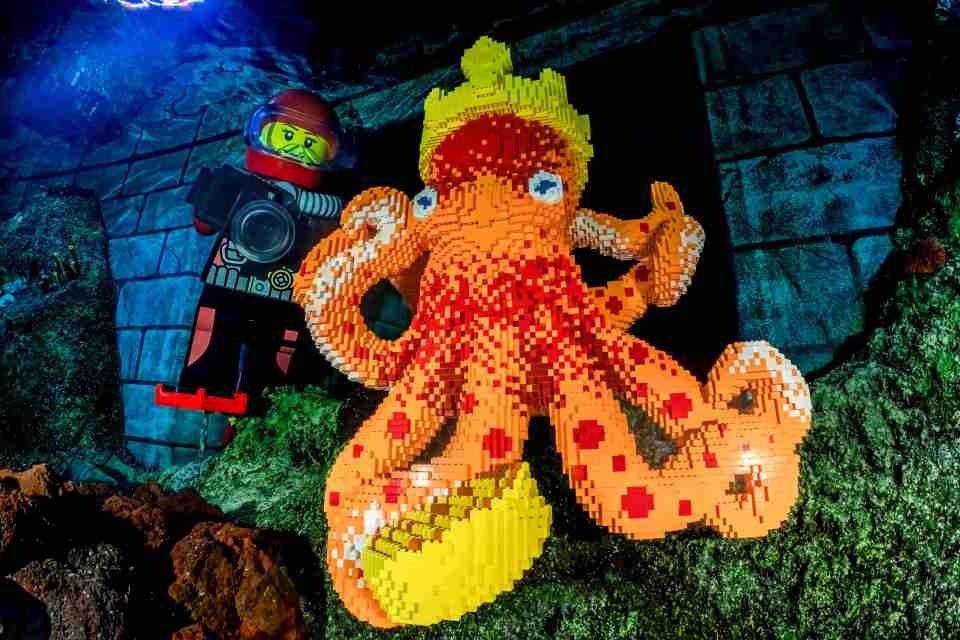 Lego diver photographing a large Lego octopus.