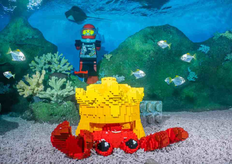 Lego diver and crab in underwater scene.