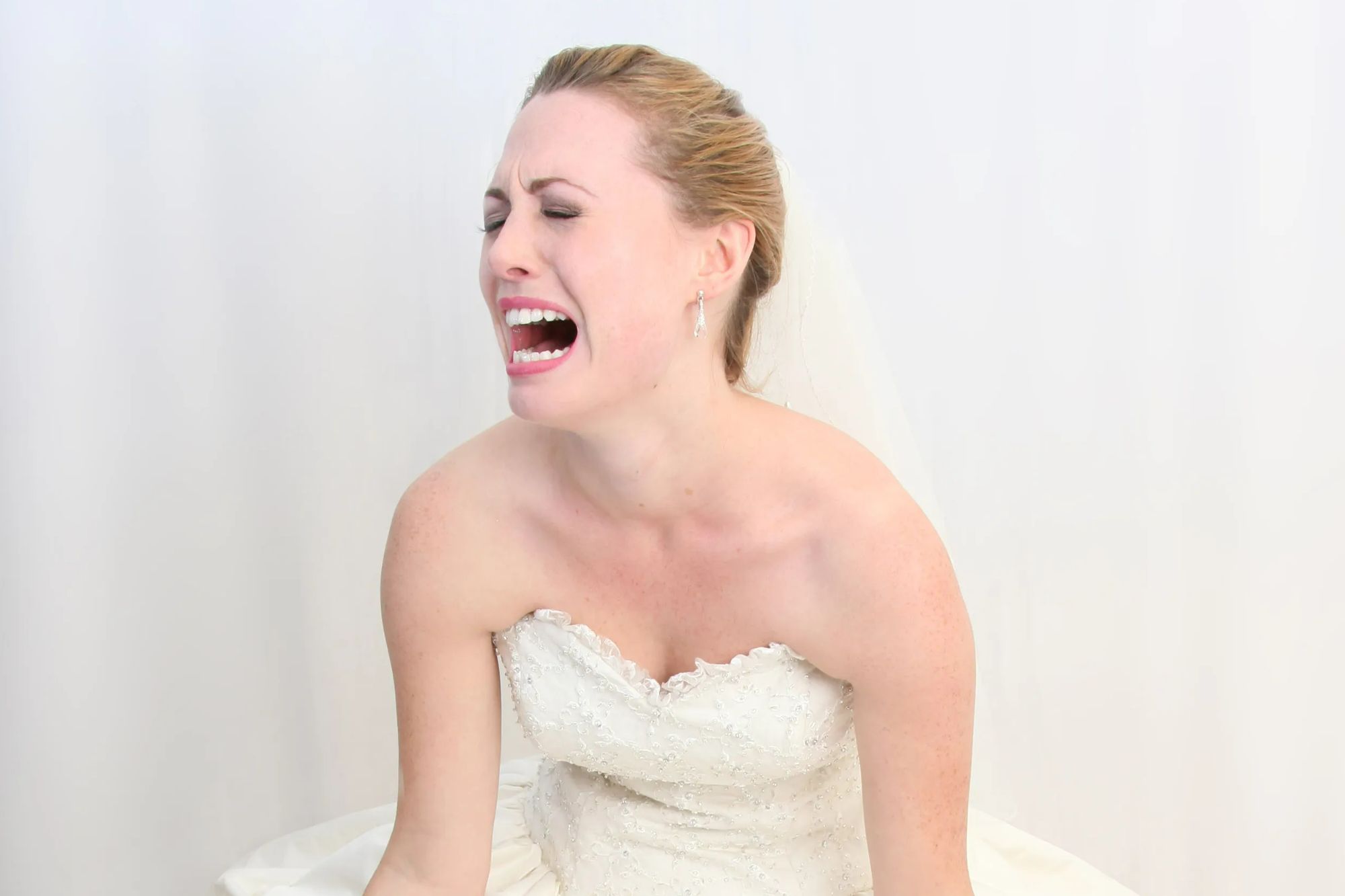 Bride crying in wedding dress.