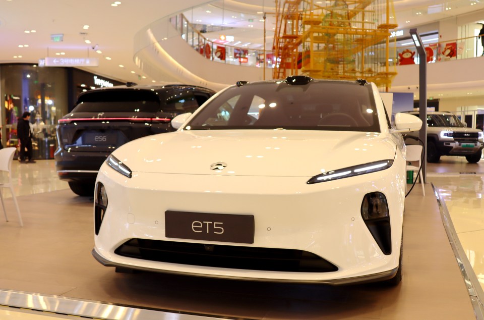 White NIO ET5 electric vehicle on display.