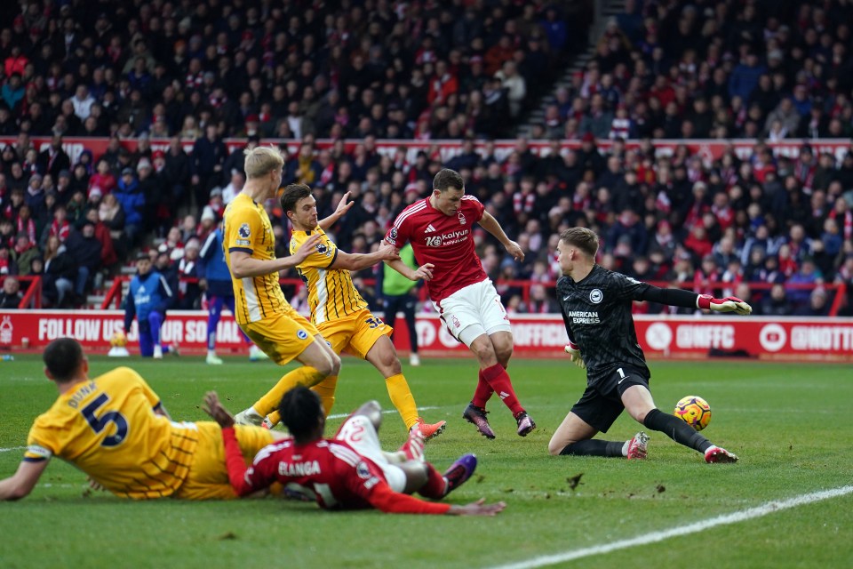 Chris Wood scoring a goal during a soccer match.