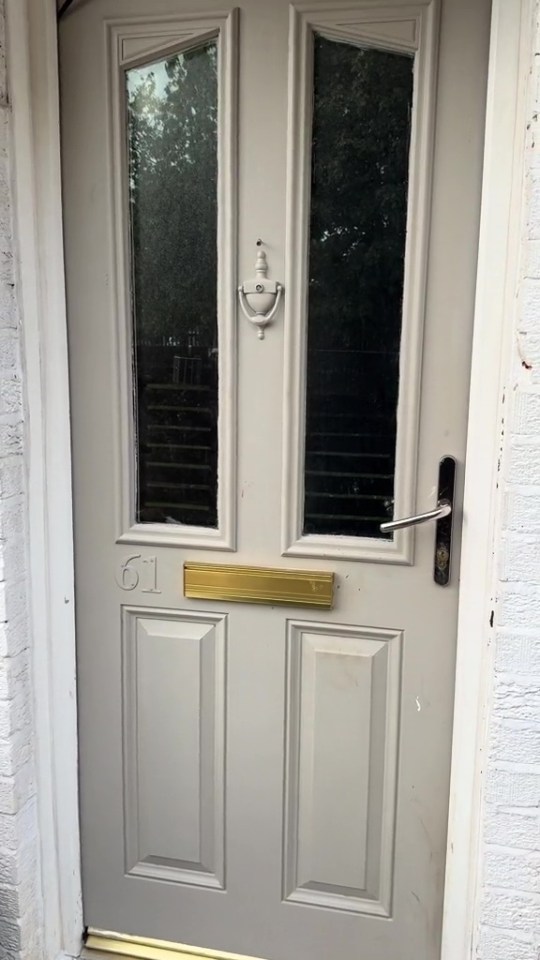 Light taupe front door with number 61.