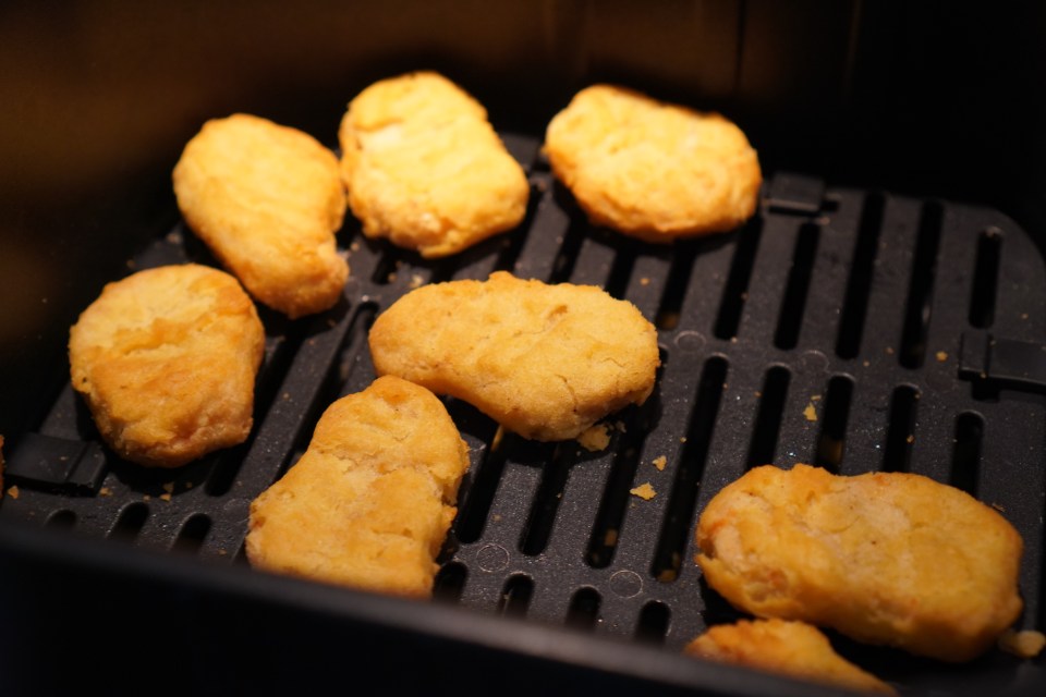 Chicken nuggets in an air fryer.