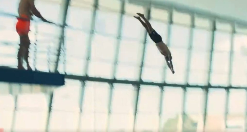 Man diving into a pool.