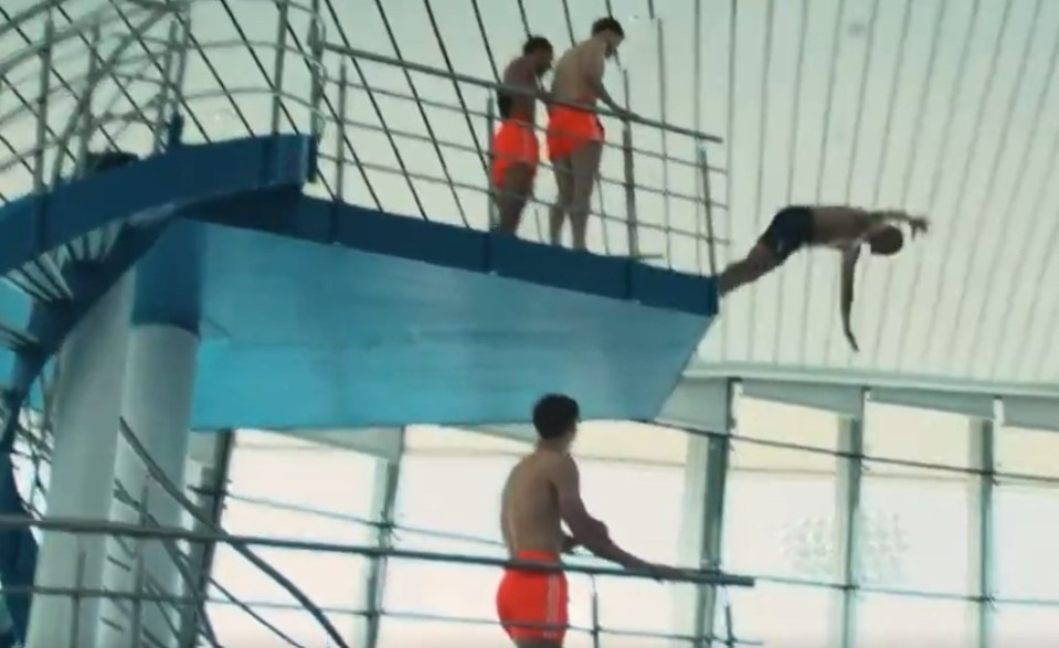 Nottingham Forest players and manager Nuno Espírito Santo diving into a pool.