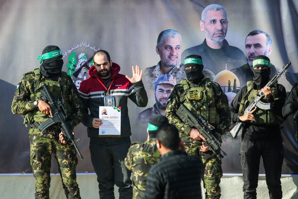 Hamas fighters escorting a released Israeli hostage.