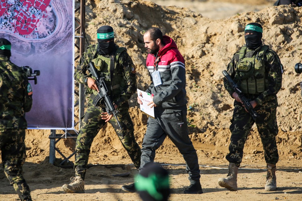 Hamas fighters escorting a released Israeli hostage.