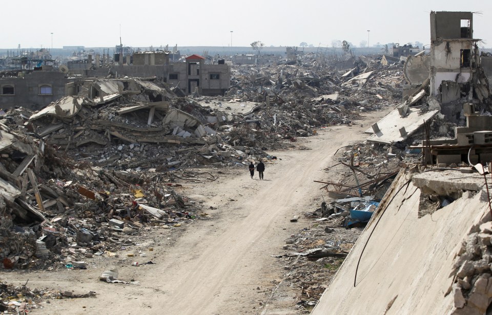 A young boy walks through the rubble of destroyed buildings in Beit Hanun, Gaza.