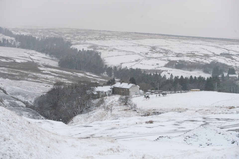 Snow-covered houses and landscape in Nenthead, Cumbria.