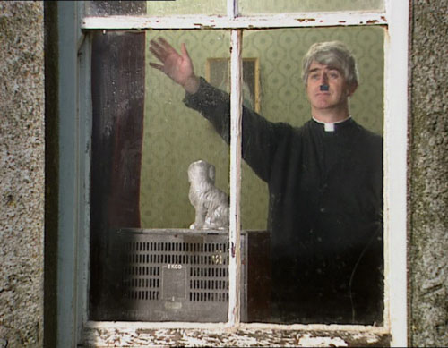 Father Ted character in a window, wearing a priest's collar and a Hitler mustache.