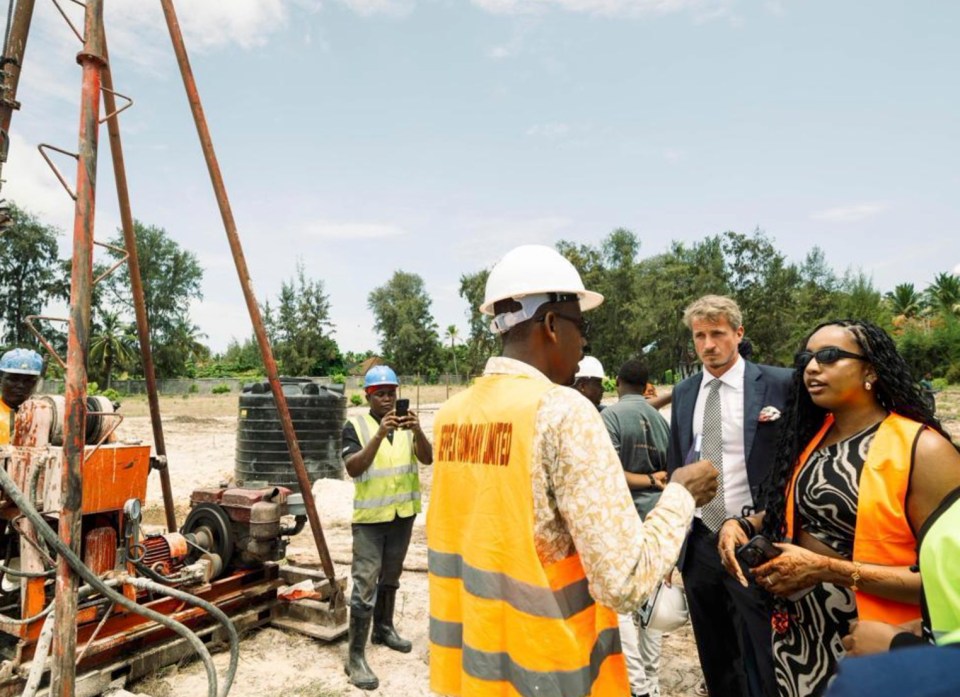 Construction site workers and supervisors discussing work.