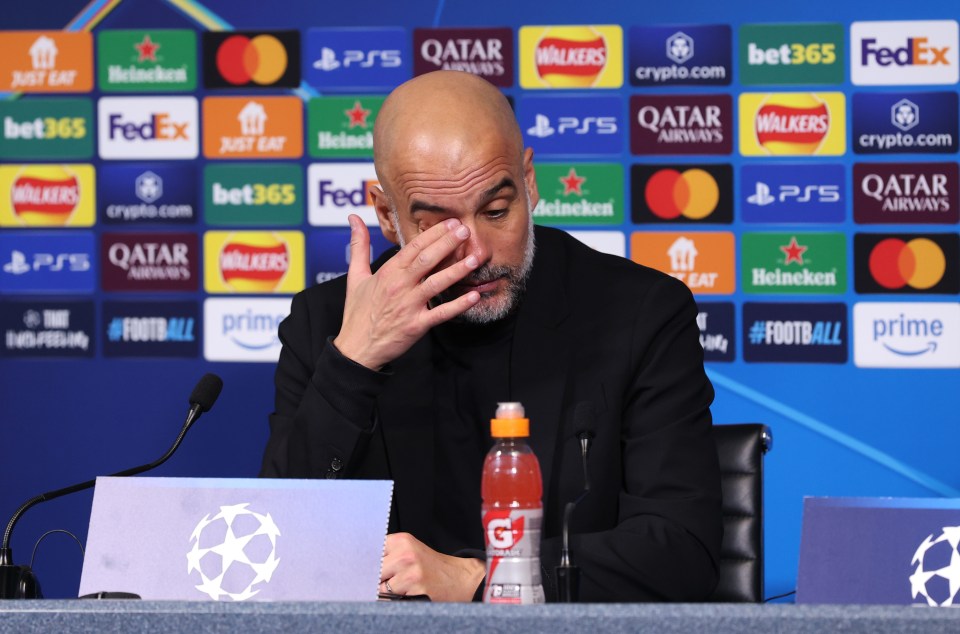 Pep Guardiola at a press conference, appearing emotional.