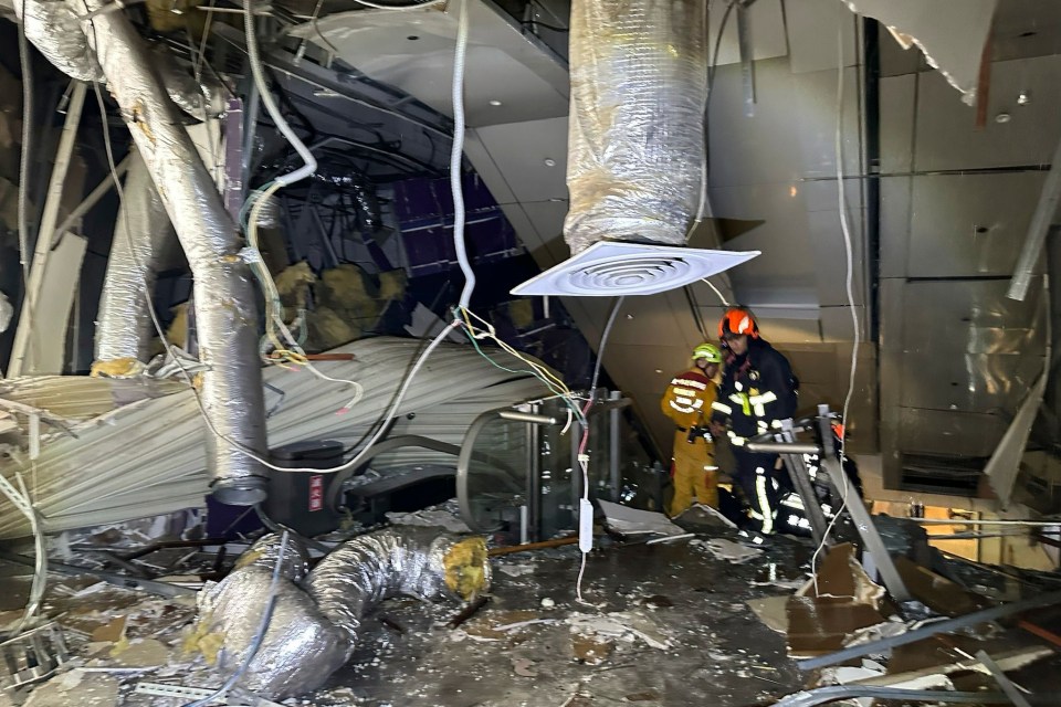 First responders surveying damage inside a building after an explosion.