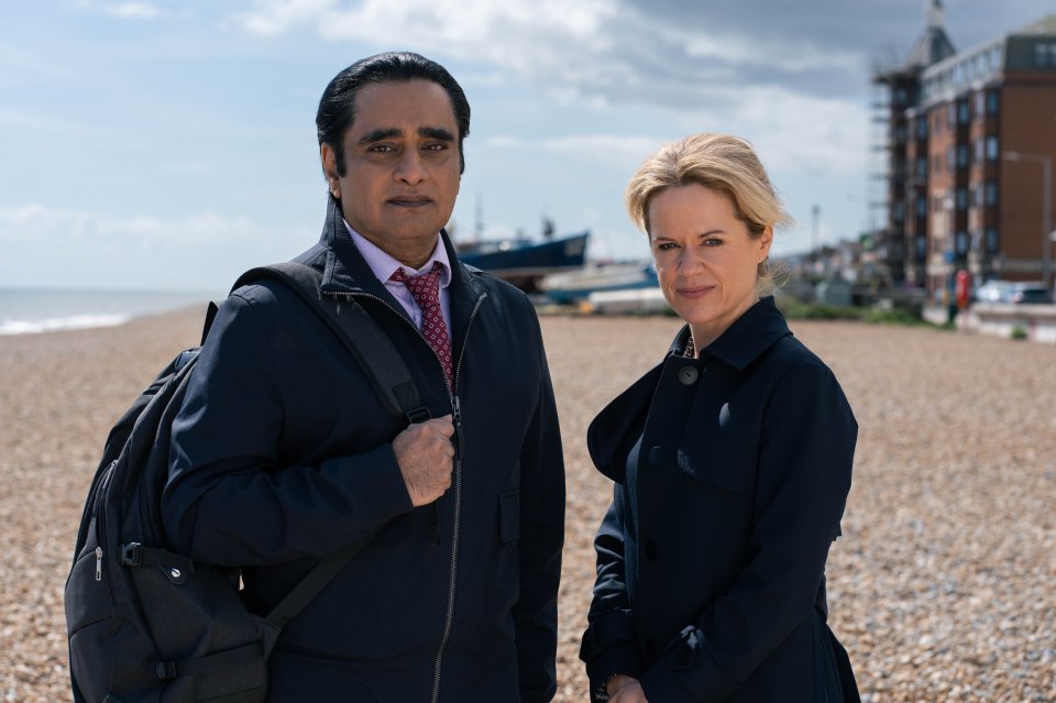 Sanjeev Bhaskar and Sinéad Keenan on a beach.