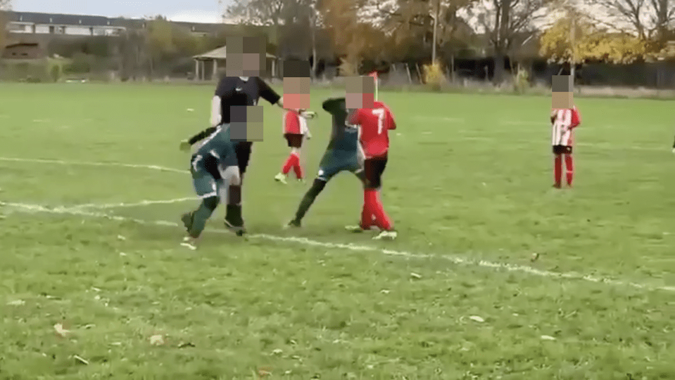 Children fighting during a soccer match.