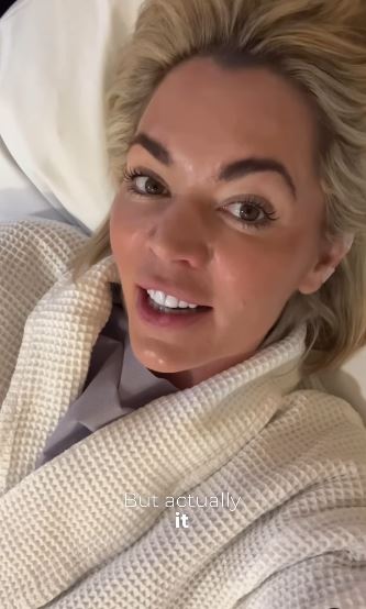 Danni Menzies in a bathrobe, sharing a health update.