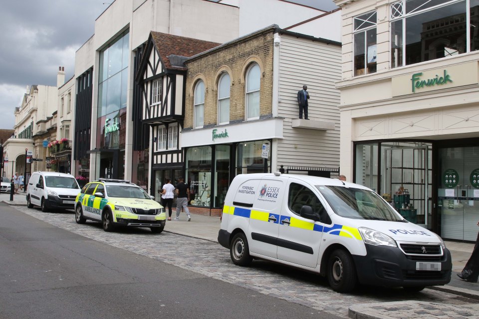 Police and ambulance vehicles outside a Fenwick department store.