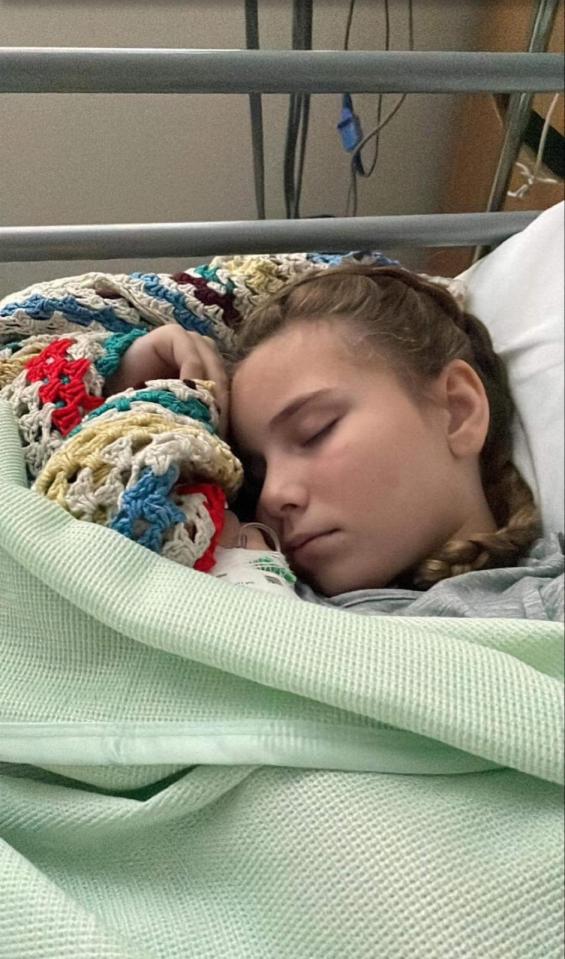 Girl sleeping in a hospital bed.