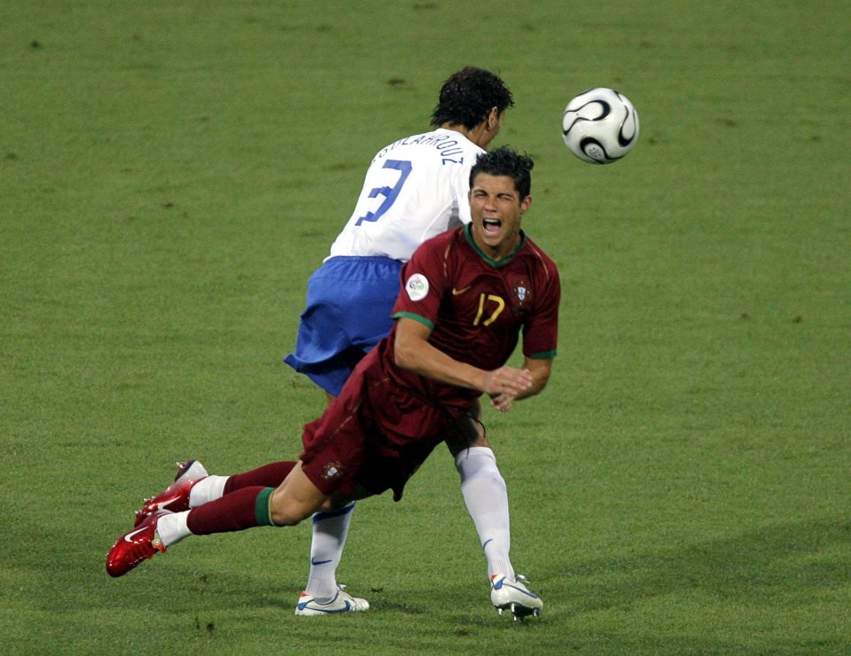 Cristiano Ronaldo being fouled during a soccer match.