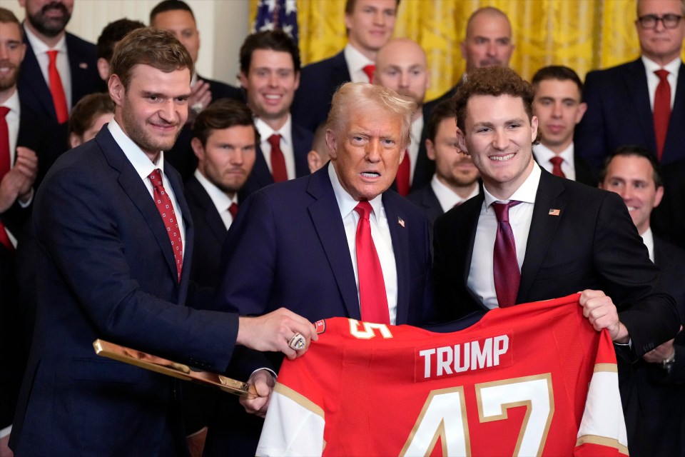 President Trump with Florida Panthers players holding a hockey jersey.