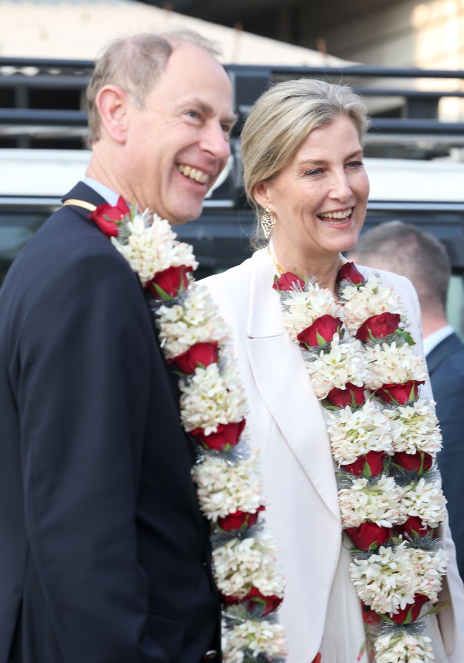 Prince Edward and Sophie, Duchess of Edinburgh, wearing flower garlands.