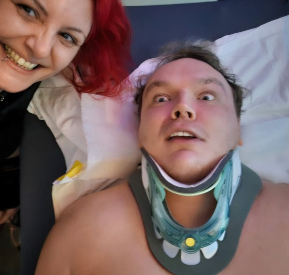 A professional wrestler in a neck brace with a woman.