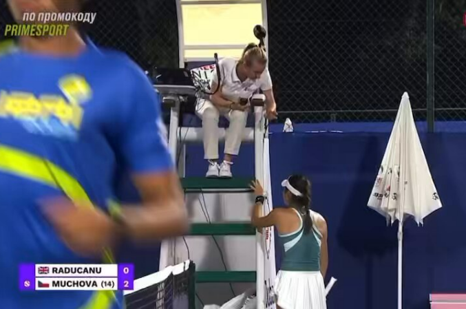 Tennis umpire reviewing a call with a player.