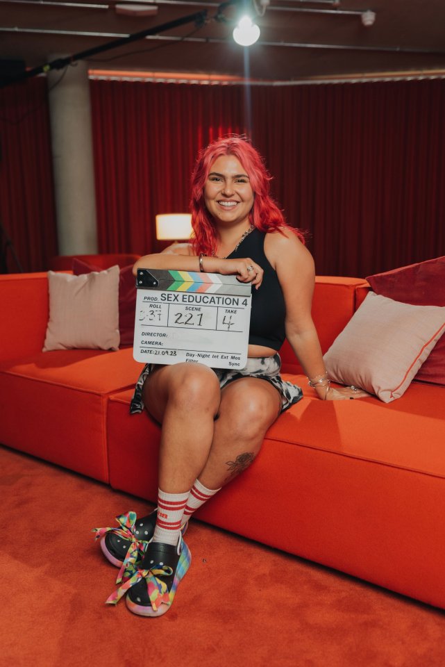 Woman holding a clapperboard for Sex Education season 4.