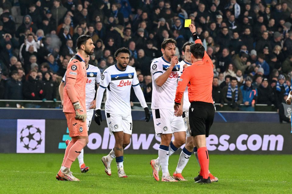 Referee showing a yellow card to a soccer player.