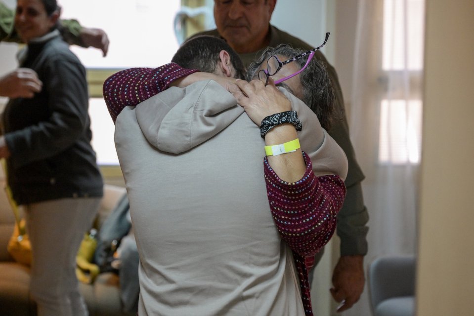 A mother embraces her son after he is released from captivity.