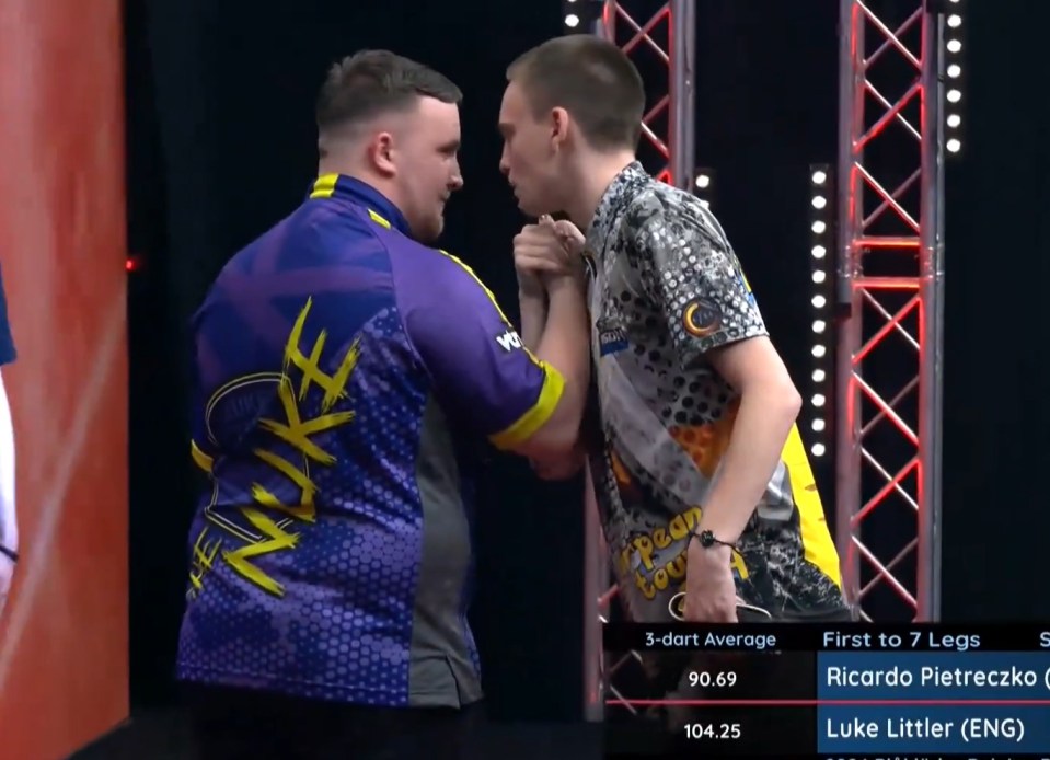 Ricardo Pietreczko and Luke Littler facing each other during a darts match.