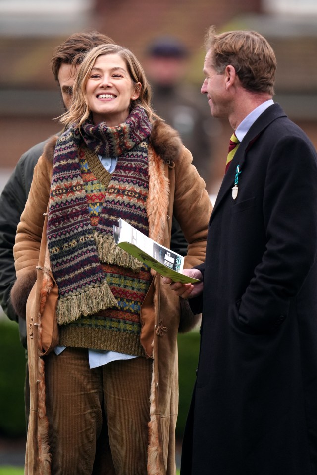 Rosamund Pike and trainer Jamie Snowden at a racecourse.