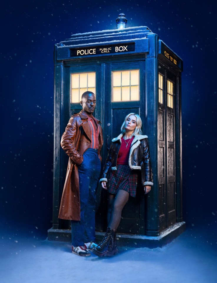 The Doctor and Ruby Sunday standing by the TARDIS in the snow.