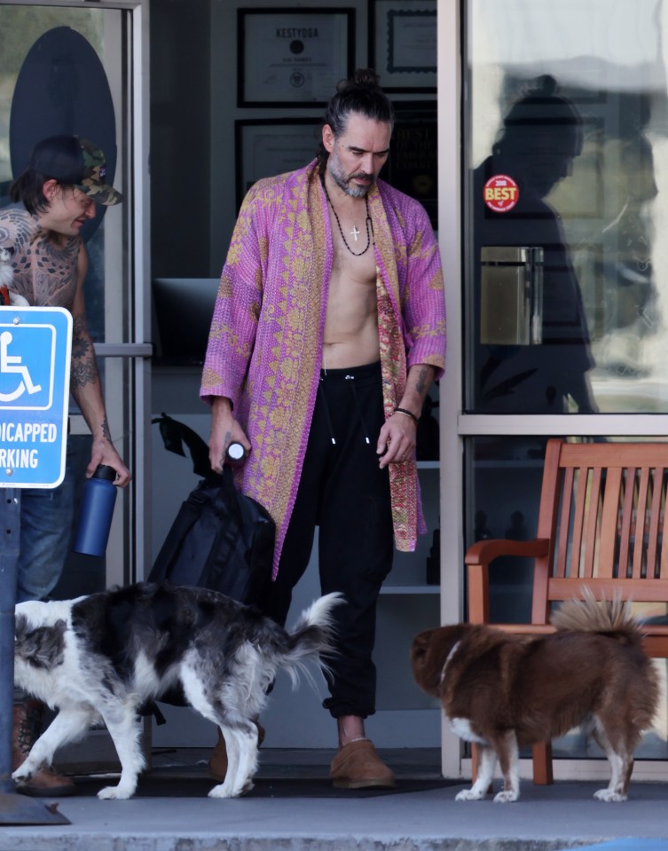 Russell Brand leaving a hot yoga class with two dogs.