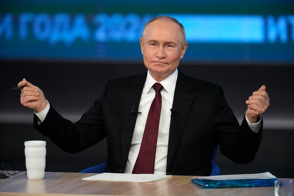 Vladimir Putin gesturing during a news conference.