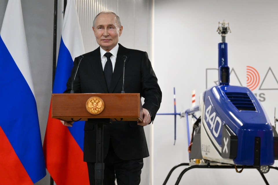 Vladimir Putin speaking at a podium.