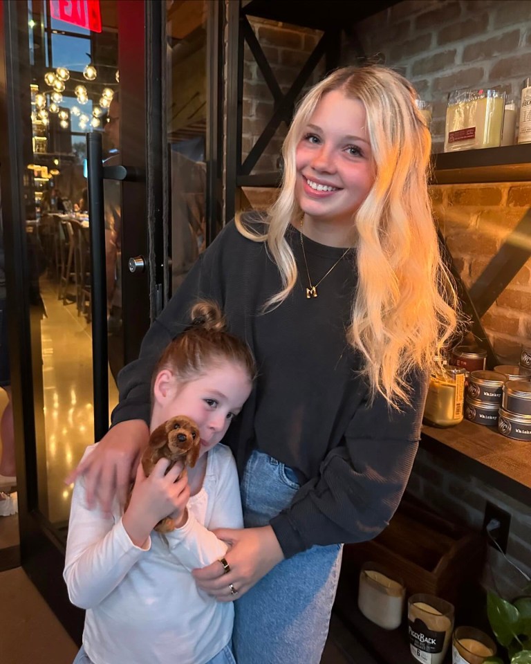 Teenage mother and young daughter with stuffed dog.