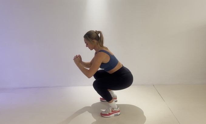 Woman performing a squat.