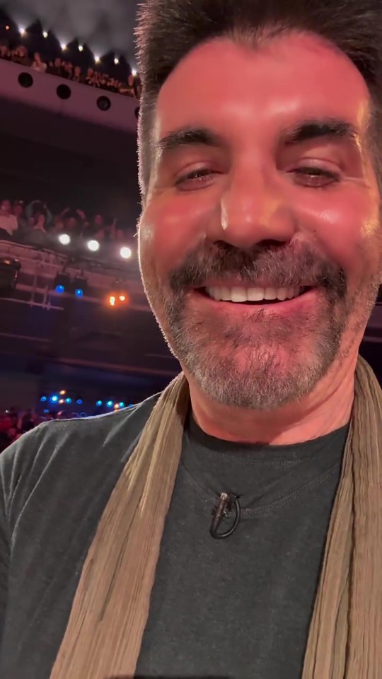 Simon Cowell smiling at the audience during Britain's Got Talent auditions.