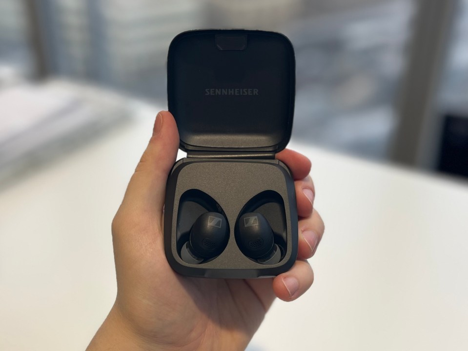 Sennheiser Momentum Sport earbuds in their charging case.