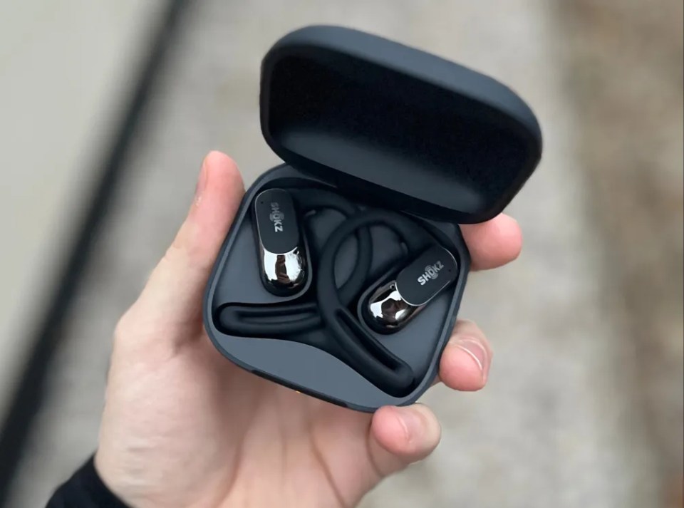 Shokz OpenFit Air earbuds in their charging case.