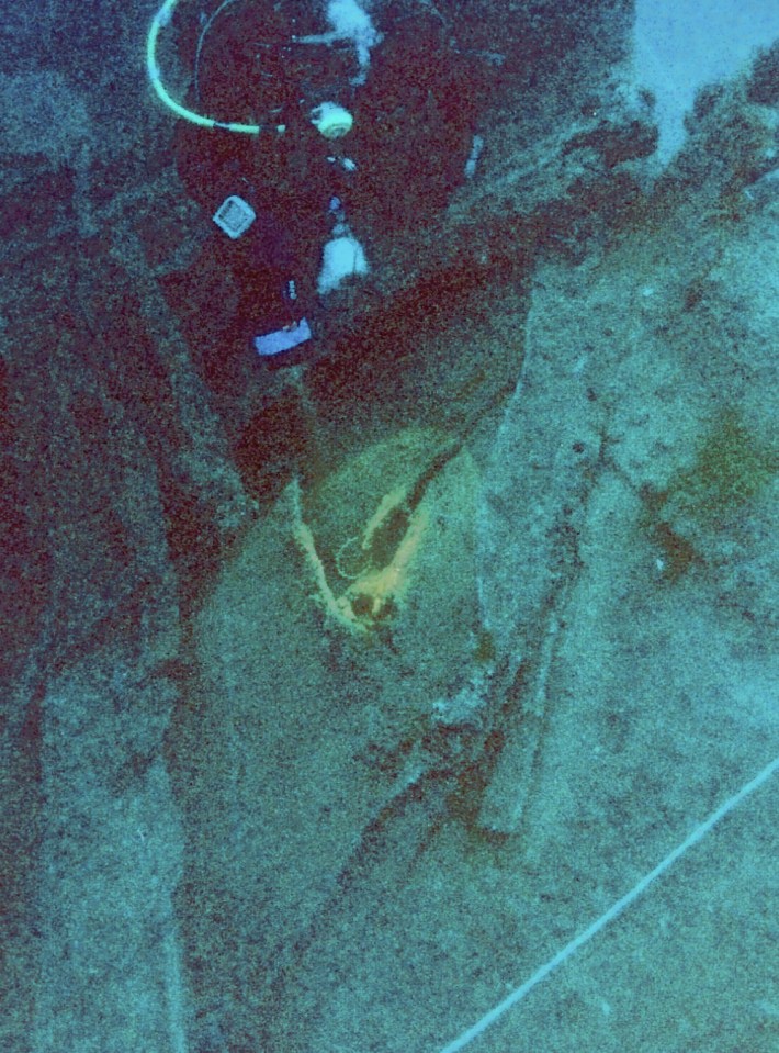 Diver examining the wreck of the Heimara in the South Euboean Gulf, Greece.