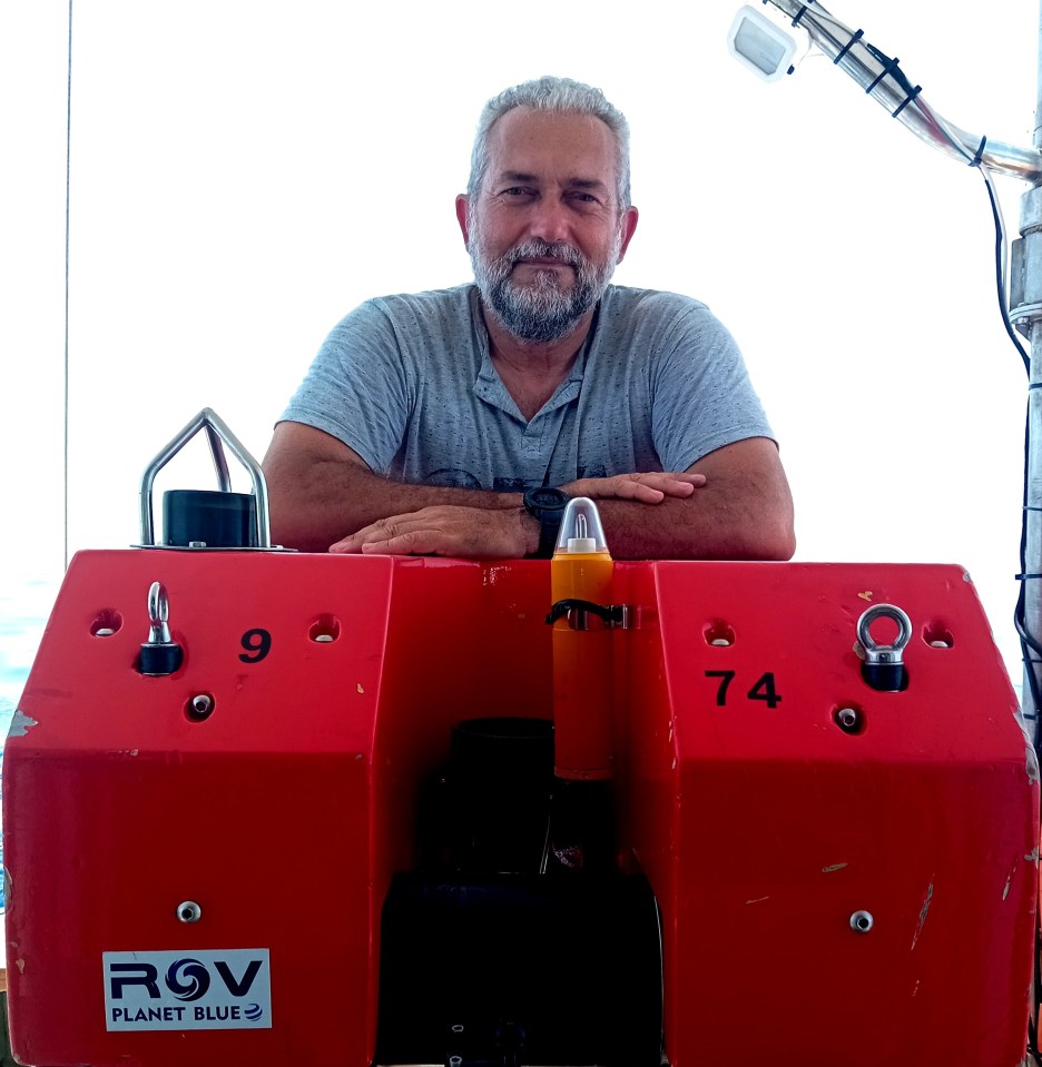 Man sitting on red ROV Planet Blue equipment.