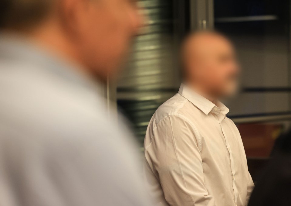 Blurred photo of a defendant in a courtroom awaiting a verdict.