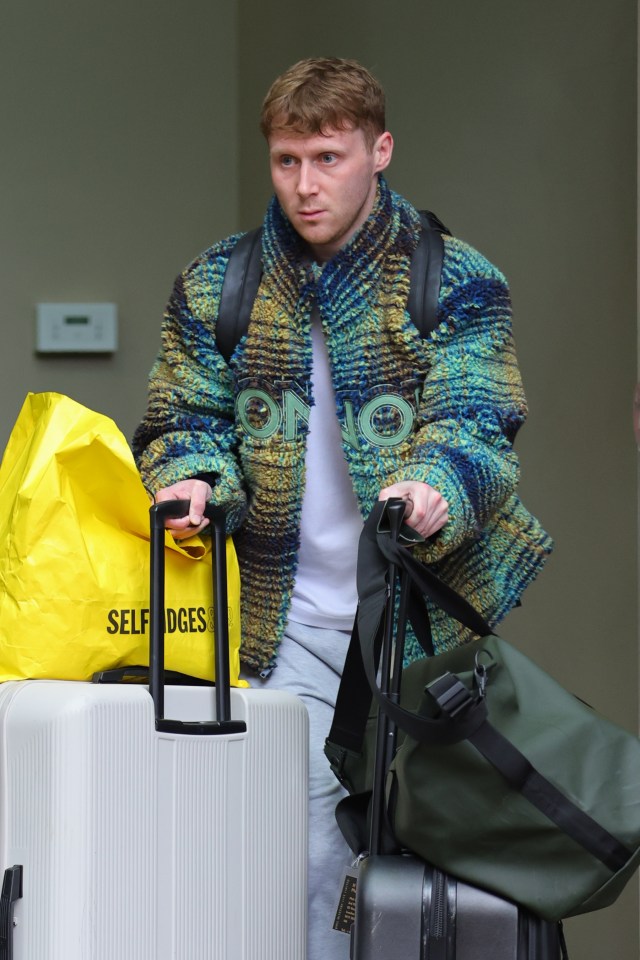 Jamie Borthwick leaving a hotel with luggage.